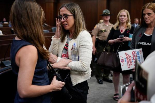 Covenant School parent Sarah Shoop Neumann, second from left, wipes tears as she and others members of the audience are removed from the House Civil Justice Subcommittee meeting by the Republican chairman during a special session of the state legislature on public safety Tuesday, Aug. 22, 2023, in Nashville, Tenn. (AP Photo/George Walker IV)
